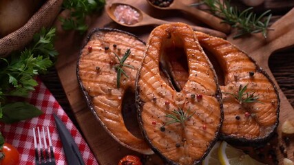 Wall Mural - Fresh raw salmon fish steak with herbs and vegetables on wooden background