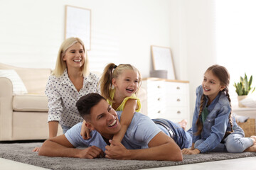 Wall Mural - Happy family spending time together at home