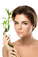 Wall Mural - Young beautiful woman with a green bamboo branch