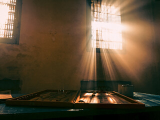 prison life. prison leisure. the sun's rays from the prison bars. backgammon game in prison