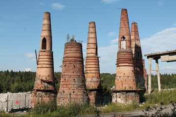 Chimneys of an abandoned old factory in the forest