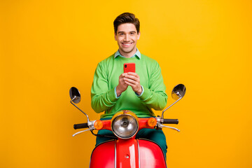 Poster - Portrait of handsome positive guy toothy smile hold device nice comment isolated on yellow color background