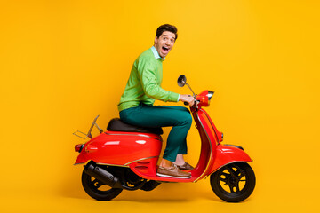 Canvas Print - Full length profile photo of handsome guy driving moped open mouth wear sweater isolated on yellow color background