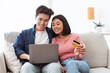 © Prostock-studio - Japanese Couple Shopping Online Using Laptop And Credit Card Indoor