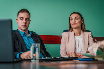 Two successful business partners man and woman working at meeting in office