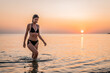 © Vladimir Borovic - Young beautiful woman having fun in water at beach. Summer photo of young beautiful girl in sea swimming and having fun. Female on beach enjoying sea vacation traveling