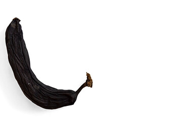 dried banana brown in peel on white background close-up