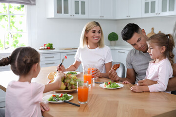 Sticker - Happy family having breakfast together at table in modern kitchen