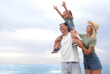 Sticker - Happy family spending time together near sea on sunny summer day