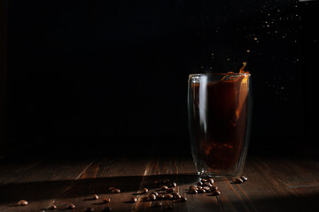 Wall Mural - Splash of ice coffee drink on a brown background.