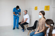 © Prostock-studio - African American doctor talking to mature male patient, checking his health before covid-19 vaccination at clinic