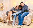 © soleg - portrait of a family sitting on a sofa at home