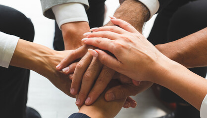 Wall Mural - close up picture of hands of multiethnic business team touching in circle for sign of unity and integrity. togerther concept