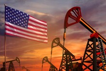 USA Oil Industry Concept. Industrial Illustration - USA Flag And Oil Wells With The Red And Blue Sunset Or Sunrise Sky Background - 3D Illustration