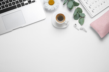 composition with cup of coffee and laptop on white background, top view