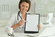 © aletia2011 - Portrait of  smiling female doctor  showing clipboard in hospital