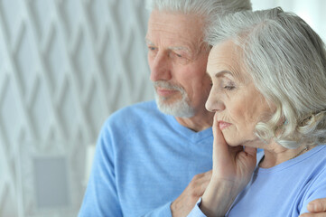 Canvas Print - Portrait of sad senior couple posing at home