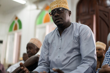 Black Muslim adult man praying inside mosque on Friday