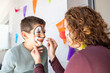 © Victor - Mother painting her son's face like a clown