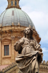 statue with cathedral