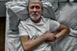 © alfa27 - old man is stressed out by getting sick on bed, holding hands on chest, he was diagnosed with high blood pressure and cancer.