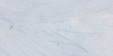 Panorama View From Above On Texture Of Snow Covered Road With Car Tire Tracks And Footprints