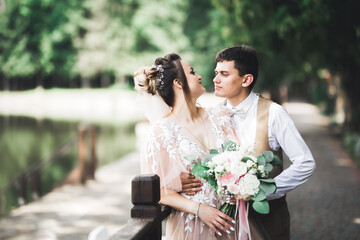 Wall Mural - Romantic wedding moment, couple of newlyweds smiling portrait, bride and groom hugging