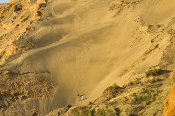 Climbing the sand dunes at Hamilton's Gap, New Zealand