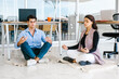 © Marcos - latin business people meditating and doing yoga in office in Mexico city