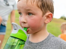 Children Drinking Water. A Thirsty Boy Taking A Water Break After Playing Outdoor.