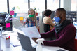 © WavebreakMediaMicro - Two diverse business people wearing face masks in creative office