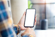 © panitan - cell phone blank white screen mockup.woman hand holding texting using mobile on desk at office.background empty space for advertise.work people contact marketing business,technology