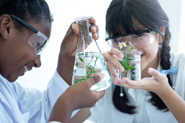 multi-ethnic student, african mixed-race and asian are doing a scientific experiment in the laborato