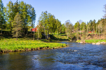 Beautiful river valley with houses a sunny spring day