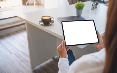 Mockup image of a woman holding digital tablet with blank white desktop screen