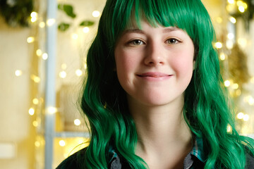 Portrait of happy beautiful girl with green hair. Attractive teen girl smiling, lifestyles.