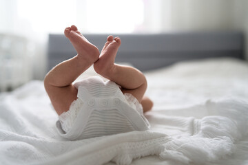 One week newborn adorable innocent baby lying at baycot and funny yawning.Portrait of sleepy caucasian infant tired child on bed. High quality photo