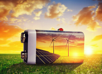 Wall Mural - battery with solar panels and wind turbines in meadow at sunset. the concept of sustainable resource