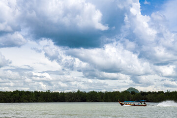 Poster - Beautiful seascape with azure water of the Adaman Sea with blue sky and clouds. Traditional boats: longteyla. Thailand.