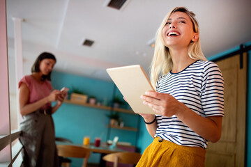 Portrait of pretty student or businesswoman in smart casual using digital tablet