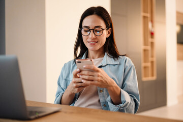 beautiful woman using mobile phone and laptop computer
