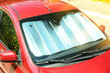 © New Africa - Sun shade under windshield in car, closeup. Heat protection