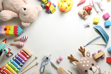 Wall Mural - Frame made of different toys on light background, flat lay. Space for text