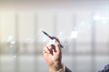 Man hand with pen working with abstract virtual financial graph on blurred office background, forex and investment concept. Multiexposure