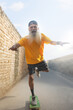 © IndiaPix - A BEARDED OLD MAN HAPPILY SKATING ON A NARROW ROAD