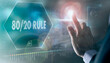 © Duncan Andison - A businessman controlling a futuristic display with a 80/20 Rule business concept on it.