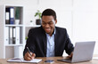 © Prostock-studio - Smiling african american entrepreneur having online training in office