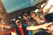 © Zoran Zeremski - Three best friends enjoying traveling in the car, sitting in rear seat and having lots of fun on a road trip.