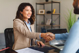 Fototapeta Panele - Young woman signing contracts and handshake with a manager