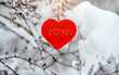 © licvin - Symbol of love hangs on snow-covered spruce